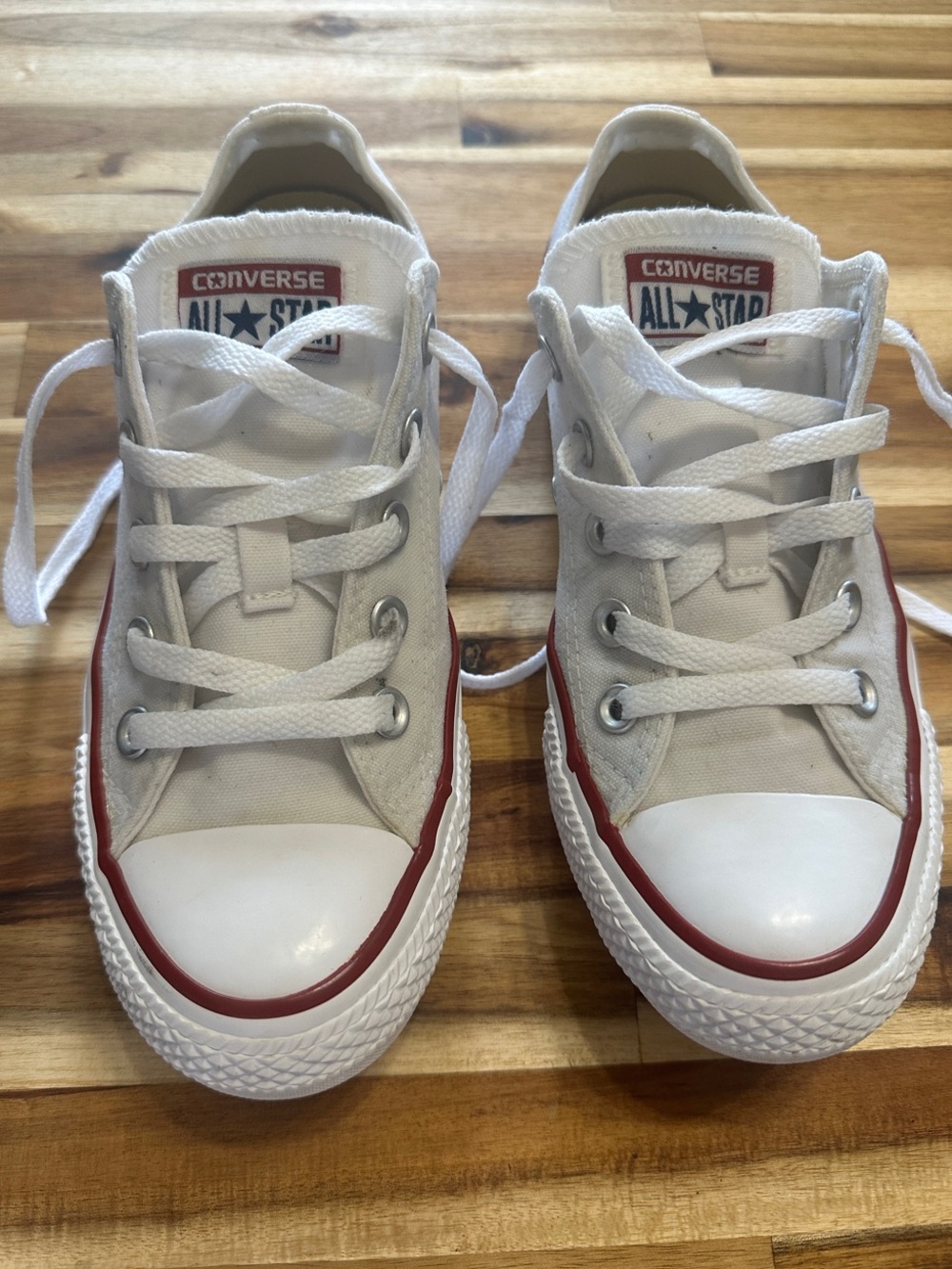 Converse White Low-Top Sneakers with Red Trim. Mens size 4, women’s size 6.